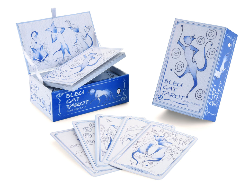 The Bleu Cat Tarot by Schiffer Publishing, Ltd. is shown in a light blue box with a stylized cat; whimsical cat tarot cards are spread in front while the deck remains partially inside the open package.
