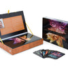 The Lenormand Cartomancy kit by Schiffer Publishing, Ltd. features a colorful guidebook and deck in an open box. Nearby, the closed box displays vivid artwork with several Lenormand fortune telling cards fanned out on a white surface.