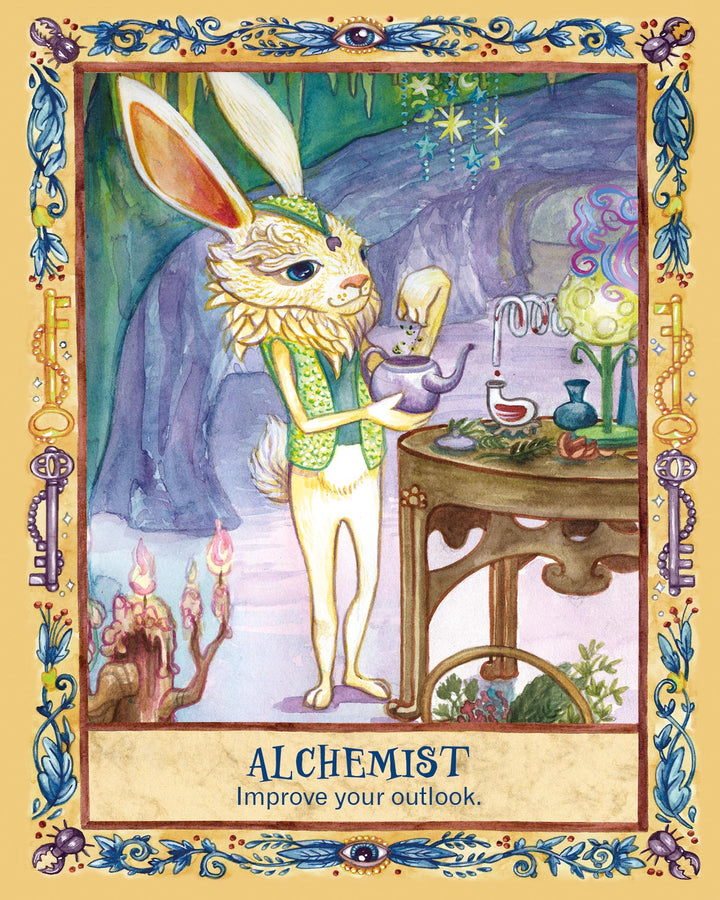 A white rabbit in a vest mixes potions at a glowing, whimsical table. Candles and swirling patterns fill the magical cave. Text reads, Secret Woods by Schiffer Publishing, Ltd.: Healing art cards for inspiration and an improved outlook.