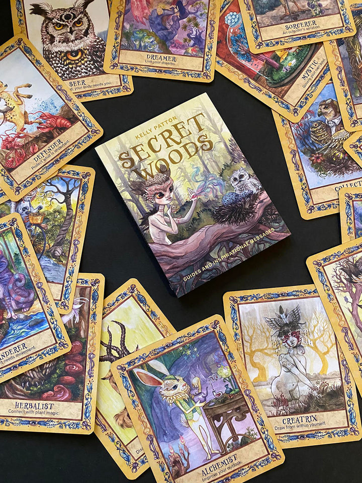 Secret Woods by Schiffer Publishing, Ltd. is a deck of illustrated oracle cards featuring whimsical fantasy characters, animals, and vibrant woodland scenes to inspire intuition and healing.