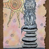 A gray cat sits atop balanced stones, embodying animal symbolism beneath a swirling sun. Pastel hues enhance the mood as BALANCE / IMBALANCE appears below. Product: The Everglow by Schiffer Publishing, Ltd.