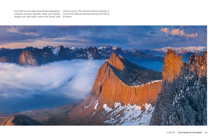 Experience the vibrant Colors of the Earth with Schiffer Publishing, Ltd.’s "The Colors of the Earth," featuring panoramic views of rugged mountain peaks in sunlight, snow patches, drifting clouds, and distant ranges under a blue sky.