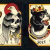 The Cut-Ups 2 from Schiffer Publishing, Ltd. features two hand-painted tattoo flash panels: a sword with snake, cross, eagle on skull; and a crowned bear, skull-headed mermaid, and "2021"—all in bold red, black, and yellow traditional style.