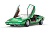 A green Automobili Lamborghini by Schiffer Publishing, Ltd. luxury sports car with both scissor doors open, viewed from the front left on a white background.