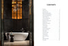 A freestanding white bathtub graces a luxurious bathroom with dark walls in this Midwest Home by Schiffer Publishing, Ltd., featuring a tall window, globe lights, side table, and a contents list shown on the next page.