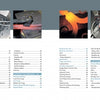 An open copy of "The Book of Forging" by Schiffer Publishing, Ltd. reveals its table of contents, showing forging techniques and page numbers, with images of heated metalwork and blacksmith tools above the text on both pages.
