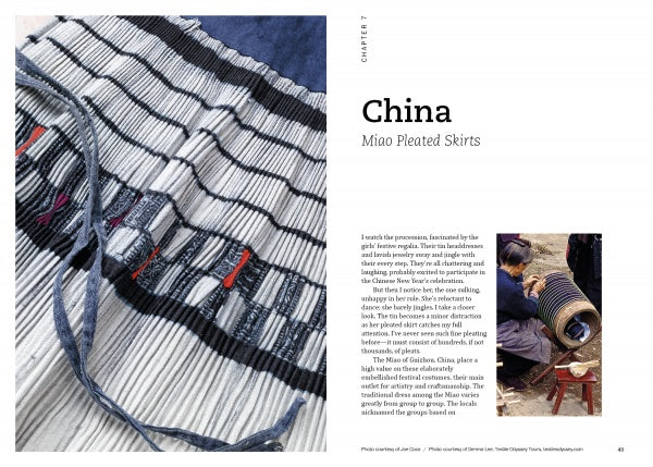A close-up of a pleated skirt with black, white, and blue stripes appears on the left page; on the right, two people handcraft pleats outdoors in *Threads Around the World* by Schiffer Publishing, Ltd., highlighting heritage textile crafts.