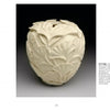 Wood Art Today 2 by Schiffer Publishing, Ltd. features a cream-colored, intricately carved apple-shaped vessel adorned with delicate ginkgo leaf patterns, highlighting exquisite wood craftsmanship on a simple white background.