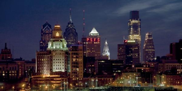 Capture the beauty of Philadelphia with Schiffer Publishing, Ltd.'s "Philadelphia," showcasing the city skyline at dusk—illuminated skyscrapers like the PSFS building and Liberty Place shine against a dramatic night sky. Ideal for photography lovers.