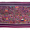Hmong Story Cloths by Schiffer Publishing, Ltd. is a vibrant textile artwork featuring intricate, colorful scenes of people, animals, and buildings with a maroon and black diamond border on a maroon background.