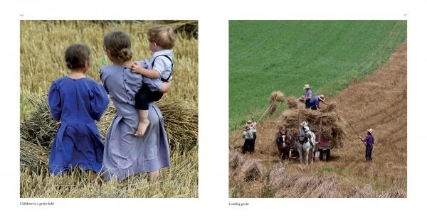 On the cover of "Lancaster County: A Keepsake" by Schiffer Publishing, Ltd., two girls and a child observe a group loading hay onto a horse-drawn wagon, all dressed in the modest, traditional attire of Lancaster's Amish community.