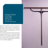 “Your Personal Hang-ups” by Schiffer Publishing, Ltd. is a wall-mounted coat rack with a wooden and brass horizontal bar and evenly spaced hooks, shown on a pale wall with details about the piece and its artist, Duncan Gowdy, on the left.