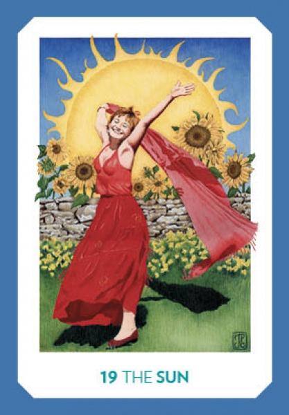 A joyful woman in a red dress dances before sunflowers and a stone wall as the bright sun shines behind her. The card, titled 19 THE SUN, radiates positive energy in the Gaian Tarot by Schiffer Publishing, Ltd.