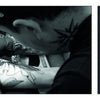 A tattoo artist inks a client’s arm in a black-and-white shot; beside it is Schiffer Publishing, Ltd.'s Italian Tattoo Flash showing a vivid woman with roses and “Best of Times” above her head inside a red heart.