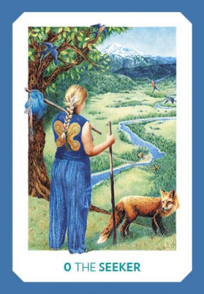 A blonde figure in butterfly-blue, holding a bundle, stands by a tree and river near mountains with a fox nearby. Inspired by the Gaian Tarot from Schiffer Publishing, Ltd., the card reads 0 THE SEEKER.