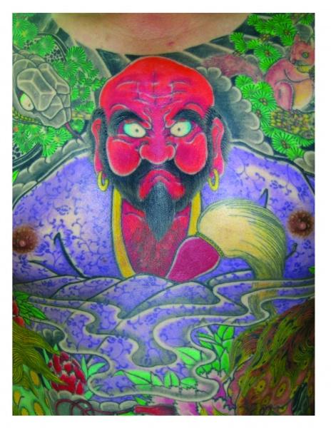 Studying Horiyoshi III by Schiffer Publishing, Ltd. features colorful Japanese tattoo art—a fierce, red-faced man with black beard and gold earrings amid vibrant plants, animals, and swirling purple water—celebrating classic Horiyoshi III style.