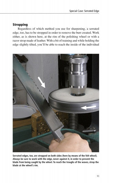 A person holds a serrated knife blade to a polishing wheel for stropping. Two white arrows show its position and movement. "Knife Sharpening Made Easy" by Schiffer Publishing, Ltd. provides a guide for honing serrated knives.