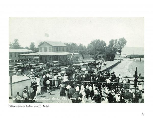 A crowd in early 20th-century attire waits near a dock for the excursion boat Colonial at Belle Isle, evoking vintage postcards from "Colonial Beach, Virginia" by Schiffer Publishing, Ltd., with a building and trees in the background.