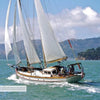 The book "Great American Schooner Yachts" by Schiffer Publishing, Ltd. showcases classic schooners sailing on vibrant blue-green waters under full sail, framed by hills, trees, and sky with other yachts in the distance.