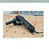 A black rotary sander from Festool®Essentials: The Sanders by Schiffer Publishing, Ltd. sits on a perforated workbench. Red arrows highlight the arbor lock by the handle and variable speed control at the rear; shelving is in the background.