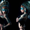 A tattooed woman in a large feathered headdress and blue face paint poses against a dark backdrop, capturing alternative pin-up style in front and side views from "Queens of Hearts" by Schiffer Publishing, Ltd.