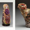 A spread from Artistry in Fiber, Vol. 2 by Schiffer Publishing, Ltd. shows Jodi Colella's profile with a black-and-white portrait and two fiber art sculptures: a vibrant doll-like figure and a U-shaped piece with layered fabric circles.