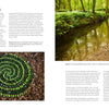A circular arrangement of small stones rests in a woodland stream with trees above, while an inset reveals a landscape artist’s spiral of green leaves—featured in Land Art by Schiffer Publishing, Ltd.